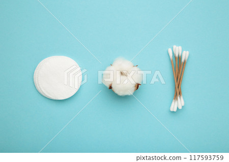Cotton swabs and sticks with flower on blue background 117593759