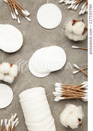 Cotton swabs and sticks with flowers on grey background 117593760