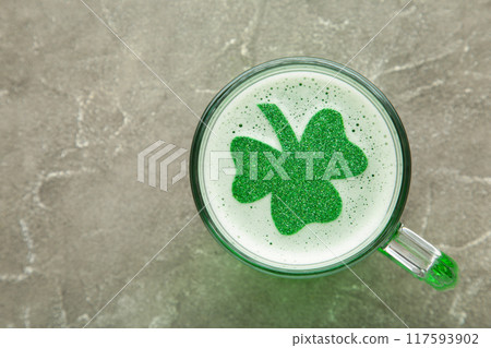 St. Patricks Day. Clover in Beer Mug on grey background with space for copy, text, your words. St. Patricks Day. Clover in Beer Mug on grey background with space for copy, text, your words. 117593902