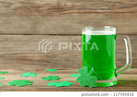 Glass of beer for St Patricks day on green background. 117593916