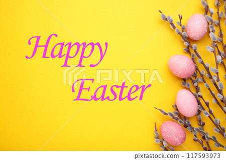 Pink easter eggs and willow branches on yellow background 117593973