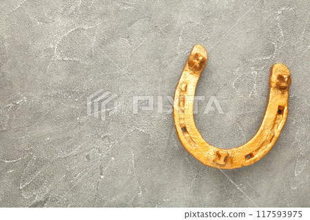 Gold horseshoe on grey background. St. Patricks day Gold horseshoe on grey background. St. Patricks day 117593975