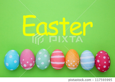 Colorful easter eggs on a green background, pastel 117593995