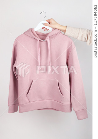 Woman wearing empty pink hoodie in hand, mockup for your own design 117594062