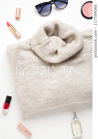 Women fashion cloth and accessories. Flat lay female casual style look with warm sweater and sunglasses. Top view. Women fashion cloth and accessories. Flat lay female casual style look with warm sweater and sunglasses. Top view. 117594066