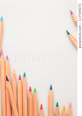 Colored pencils on the grey background. Top view. 117594073