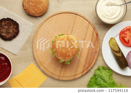 Homemade burger ingredients arranged on wooden background Homemade burger ingredients arranged on wooden background 117594118