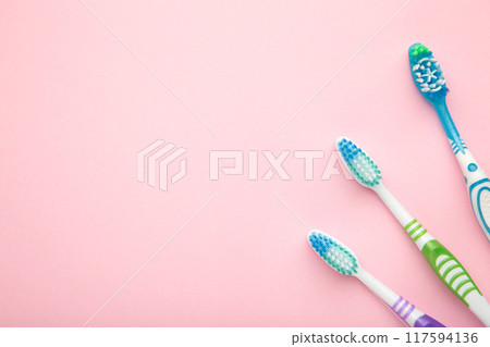 Toothbrushes on pink background with copy space. Top view Toothbrushes on pink background with copy space. Top view 117594136