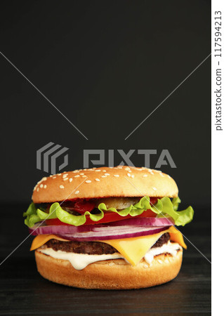 Fresh tasty burger on a dark background Fresh tasty burger on a dark background 117594213