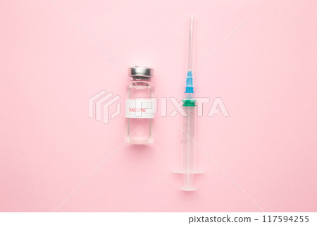 Coronavirus COVID-19 vaccine vials and syringe on pink background with copy space. Coronavirus COVID-19 vaccine vials and syringe on pink background with copy space. 117594255