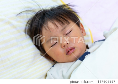 Close-up of a 2-year-old child sleeping 117594357