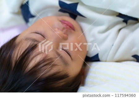 Close-up of a 2-year-old child sleeping Close-up of a 2-year-old child sleeping 117594360