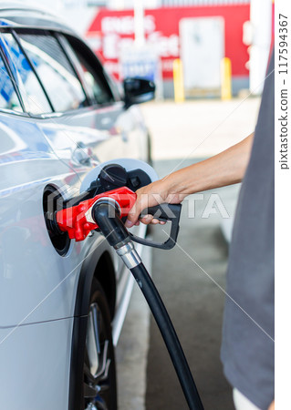 一個在加油站加油的人 117594367