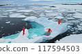Antarctica 28.11.2019- People on large floating ice iceberg in Antarctica. Scientists from polar station expedition outdoor. Icy landscape, melting glacier, wild nature of South Pole. Aerial shot 117594503