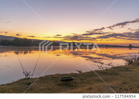 Carp fishing rods at sunrise. Carp fishing rods at sunrise. 117594954