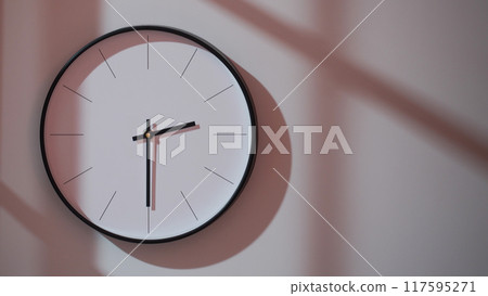 Elegant Black Clock Showing 14.30/02.30 with Shadows on Minimalist Wall - Ideal for Time Management and Interior Design Promotions Elegant Black Clock Showing 14.30/02.30 with Shadows on Minimalist Wall - Ideal for Time Management and Interior Design Promotions 117595271