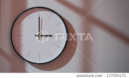 Elegant Black Clock Showing 15.00/03.00 with Shadows on Minimalist Wall - Ideal for Time Management and Interior Design Promotions Elegant Black Clock Showing 15.00/03.00 with Shadows on Minimalist Wall - Ideal for Time Management and Interior Design Promotions 117595272