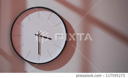 Elegant Black Clock Showing 15.30/03.30 with Shadows on Minimalist Wall - Ideal for Time Management and Interior Design Promotions Elegant Black Clock Showing 15.30/03.30 with Shadows on Minimalist Wall - Ideal for Time Management and Interior Design Promotions 117595273