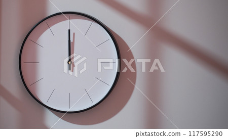 Elegant Black Clock Showing 12.00/0.00/24.00 with Shadows on Minimalist Wall - Ideal for Time Management and Interior Design Promotions Elegant Black Clock Showing 12.00/0.00/24.00 with Shadows on Minimalist Wall - Ideal for Time Management and Interior Design Promotions 117595290