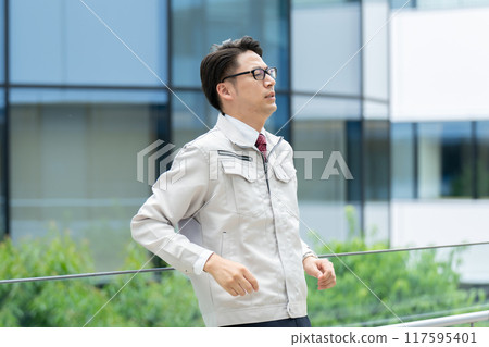 Depressed man in work clothes Depressed man in work clothes 117595401