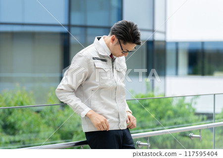 Depressed man in work clothes 117595404