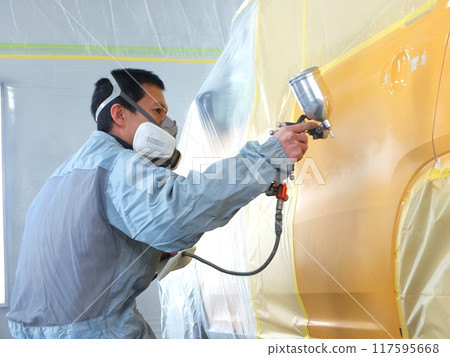 Painting work at an automobile body repair and painting factory 25 117595668