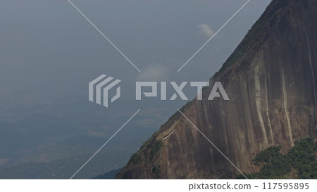 Hikers on dangerous rocky mountain cliff edge in Rio de Janeiro 117595895