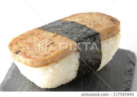Spam musubi served on a slate plate photographed on a white background Spam musubi served on a slate plate photographed on a white background 117595940