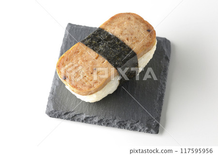 Spam musubi served on a slate plate photographed on a white background 117595956