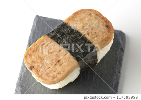 Spam musubi served on a slate plate photographed on a white background 117595959