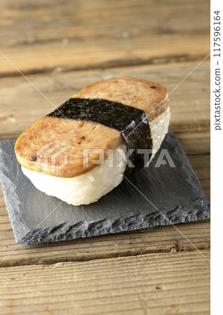 Spam musubi served on a slate plate 117596164