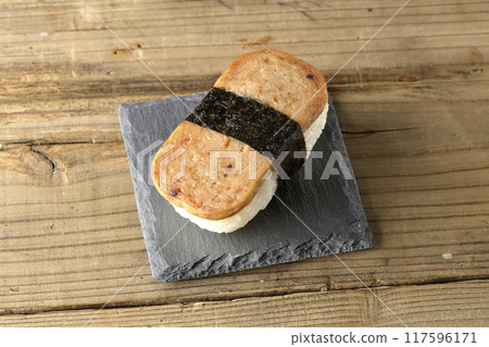 Spam musubi served on a slate plate 117596171