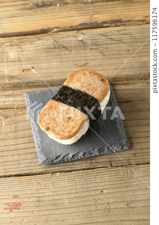 Spam musubi served on a slate plate 117596174