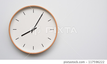 Minimalist wooden Wall Clock on White Wooden Surface with Space for Text.  Time Set at 08.05/20.05 117596222