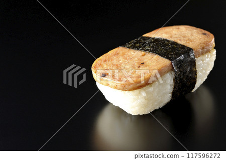 Spam musubi photographed against a black background Spam musubi photographed against a black background 117596272