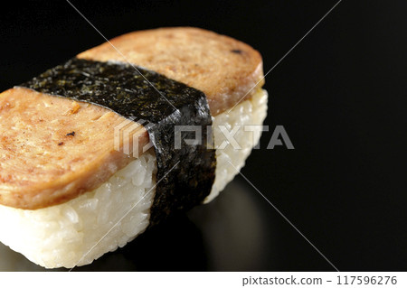 Spam musubi photographed against a black background Spam musubi photographed against a black background 117596276