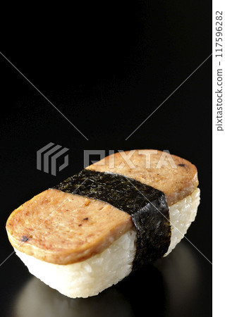 Spam musubi photographed against a black background Spam musubi photographed against a black background 117596282