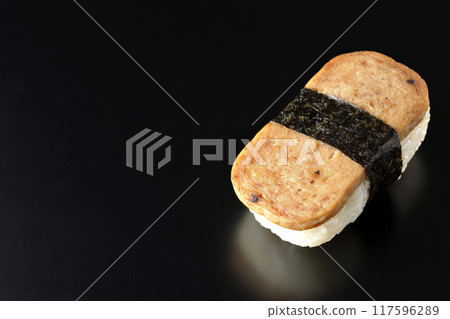 Spam musubi photographed against a black background Spam musubi photographed against a black background 117596289