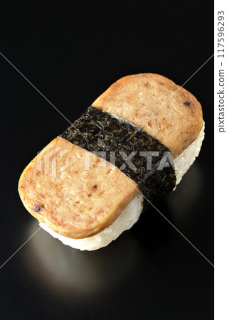 Spam musubi photographed against a black background Spam musubi photographed against a black background 117596293