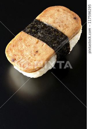Spam musubi photographed against a black background Spam musubi photographed against a black background 117596295