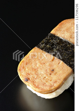 Spam musubi photographed against a black background Spam musubi photographed against a black background 117596296