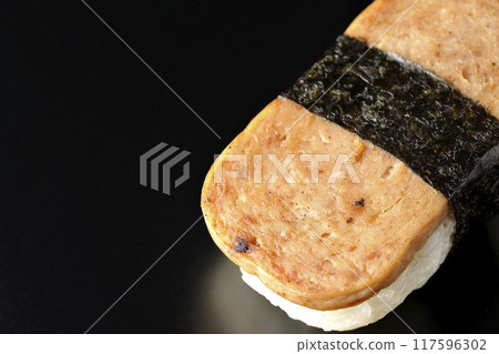 Spam musubi photographed against a black background Spam musubi photographed against a black background 117596302