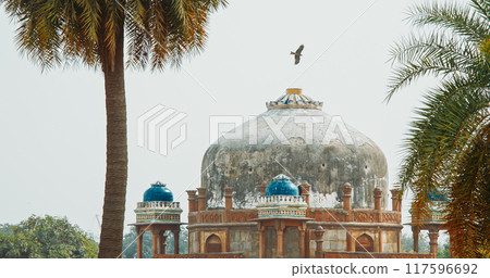 New Delhi, Delhi, India. Black Kite bird flying above Babur's Tomb near The Humayun's tomb. Famous place is Tomb of Mughal emperor, Mirza Nasir al-Din Muhammad commonly known as Humayun situated in 117596692
