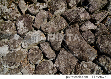 Stone wall of an old farmhouse, background material, texture 117596740