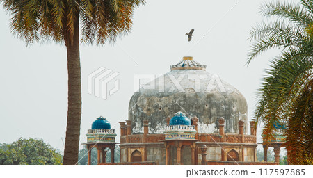 New Delhi, Delhi, India. Black Kite bird flying above Babur's Tomb near The Humayun's tomb. Famous place is Tomb of Mughal emperor, Mirza Nasir al-Din Muhammad commonly known as Humayun situated in 117597885