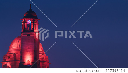 New Delhi, Delhi, India. Close up of Rashtrapati Bhavan, Bell tower and Ministry of External Affairs in Kartavya Path, Rajpath Area. Rashtrapati Bhavan in evening night illumination lights lighting New Delhi, Delhi, India. Close up of Rashtrapati Bhavan, Bell tower and Ministry of External Affairs in Kartavya Path, Rajpath Area. Rashtrapati Bhavan in evening night illumination lights lighting 117598414