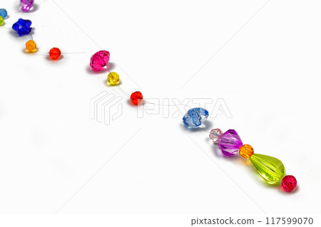 Colored beads for design on a white background 117599070