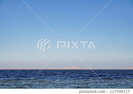 Red sea in Egypt and Tiran island (Saudi Arabia) arid mountains in the distance Red sea in Egypt and Tiran island (Saudi Arabia) arid mountains in the distance 117599117