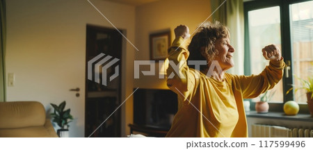 positive older woman working out and dancing at home in the room positive older woman working out and dancing at home in the room 117599496