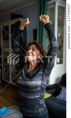 positive older woman working out and dancing at home in the room positive older woman working out and dancing at home in the room 117599497
